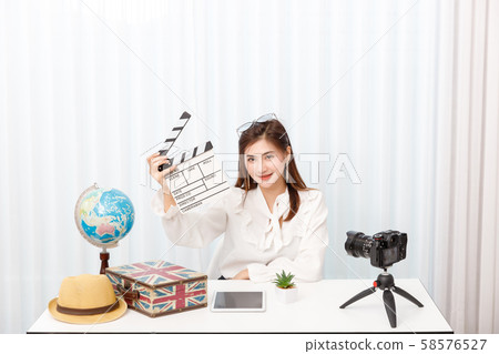 Young travel blogger girl reviewing in front of Young travel blogger girl reviewing in front of 58576527
