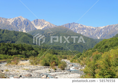 Hakuba foothills overlooking Hakuba mountain range from Hakuba Ohashi 58576558