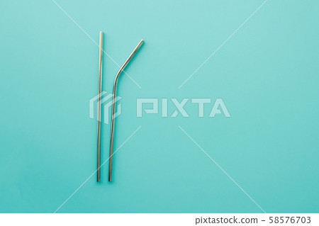 Reusable eco friendly metallic straws on trendy mint background. Reusable eco friendly metallic straws on trendy mint background. 58576703