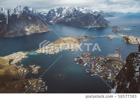 Scenic landscape of Lofoten islands: peaks, lakes, and houses. Reine village, rorbu, reinbringen 58577383
