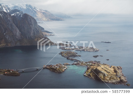 Scenic landscape of Lofoten islands: peaks, lakes, and houses. Reine village, rorbu, reinbringen Scenic landscape of Lofoten islands: peaks, lakes, and houses. Reine village, rorbu, reinbringen 58577399
