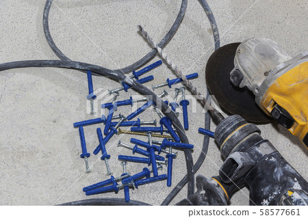 a hammer and a pile of construction dowels on the 58577661