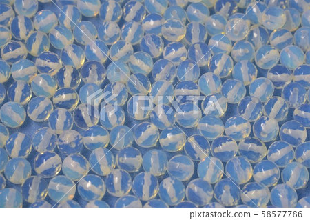 Transparent gems called Moonstone on blue sky background. Transparent gems called Moonstone on blue sky background. 58577786