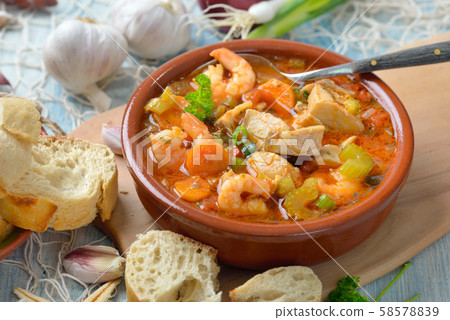 Mediterranean fish soup served with fresh white bread 58578839