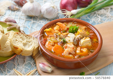 Mediterranean fish soup served with fresh white bread Mediterranean fish soup served with fresh white bread 58578840