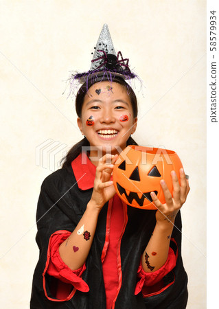 A girl who enjoys a Halloween party A girl who enjoys a Halloween party 58579934
