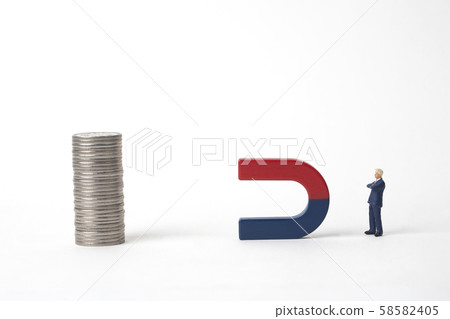 Businessman with magnet and coin tower Businessman with magnet and coin tower 58582405