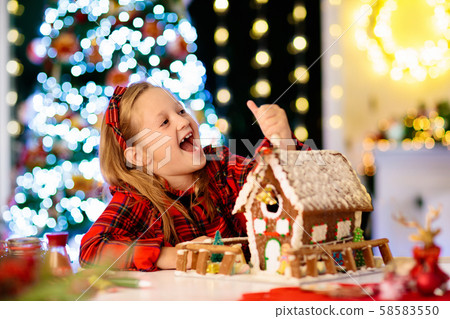 Kids baking gingerbread house. Christmas at home. Kids baking gingerbread house. Christmas at home. 58583550