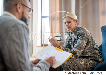 Blonde servicewoman feeling confused while having psychoanalysis Blonde servicewoman feeling confused while having psychoanalysis 58583598