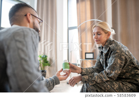Psychologist giving antianxiety pills for military woman 58583609