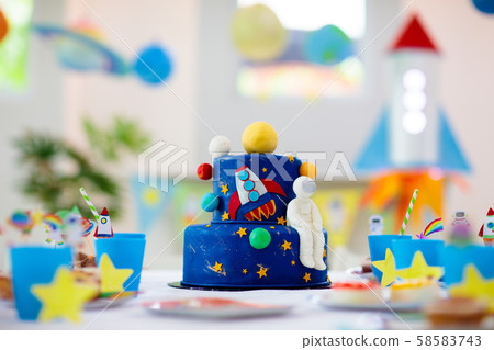 Kids space theme birthday party with cake. Kids space theme birthday party with cake. 58583743