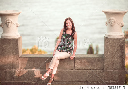 Young woman tourist posing at beautiful place Young woman tourist posing at beautiful place 58583745