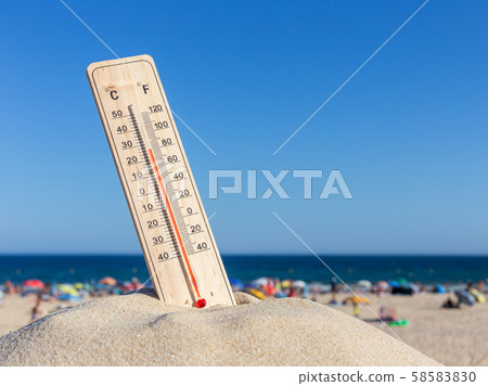 Thermometer for the temperature on the beach, in the summer in the heat. Global warming. Thermometer for the temperature on the beach, in the summer in the heat. Global warming. 58583830