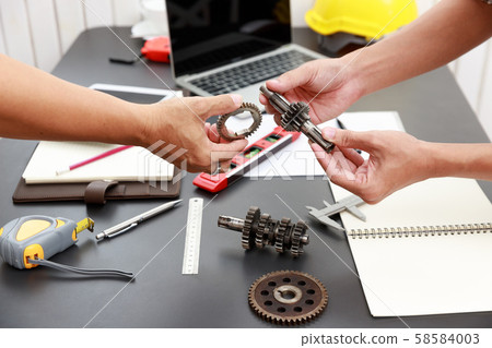 Engineer discussing and designing about mechanical 58584003