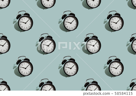 Many black classic style alarm clock isolated on green background Many black classic style alarm clock isolated on green background 58584115