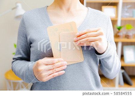 Woman with a compress Woman with a compress 58584555