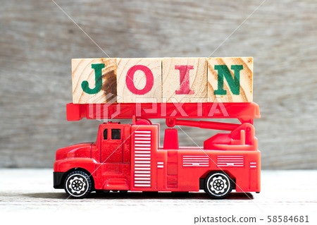 Toy fire ladder truck hold letter block in word join on wood background 58584681