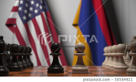 Flags of USA and Armenia behind pawns on the chessboard. Chess game or political rivalry related 3D 58584921