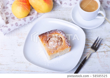 Mannik (Semolina pie) with pear and canella. In the background is a cup of coffee and fresh pears. Traditional Russian cuisine. Close-up, selective focus. 58585525