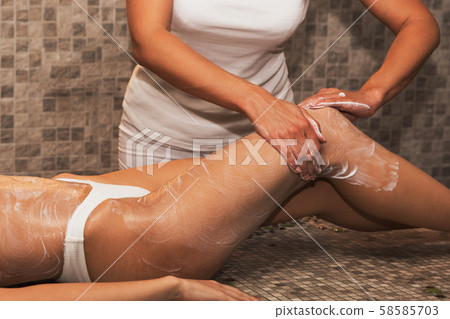 Woman having massage with cream at spa Woman having massage with cream at spa 58585703