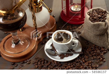 two cup with black coffee and geyser coffeepot 58586137