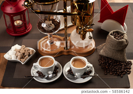 two cup with black coffee and geyser coffeepot 58586142