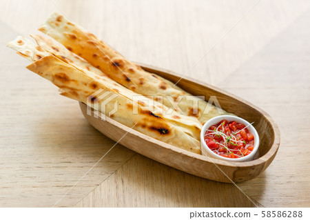 Matzo. Served with tomato and sweet pepper chutney. Matzo, matzah, or matza is unleavened flatbread 58586288
