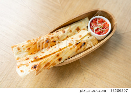 Matzo. Served with tomato and sweet pepper chutney. Matzo, matzah, or matza is unleavened flatbread 58586297