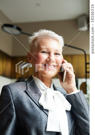 Mature woman talking on the phone Mature woman talking on the phone 58586319