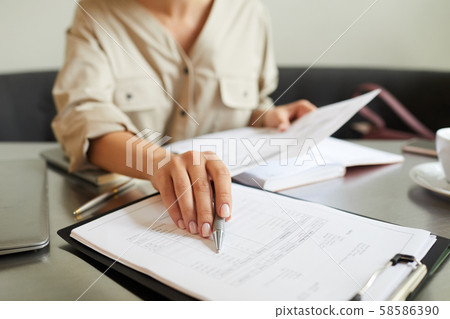 Woman working with financial report 58586390
