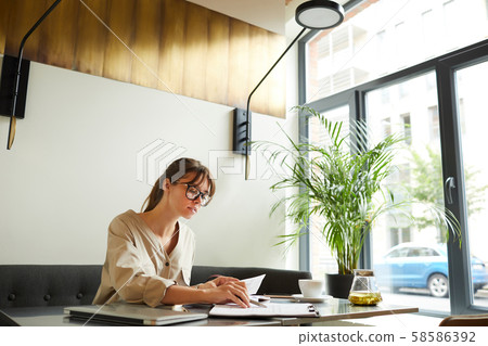 Young businesswoman working in cafe Young businesswoman working in cafe 58586392