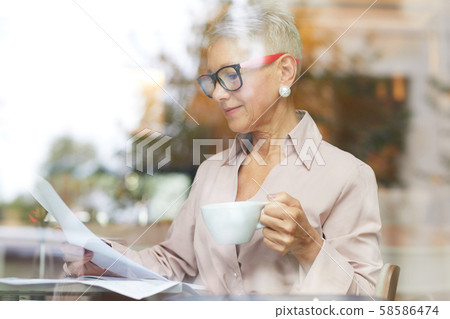 Mature businesswoman reading a contract 58586474