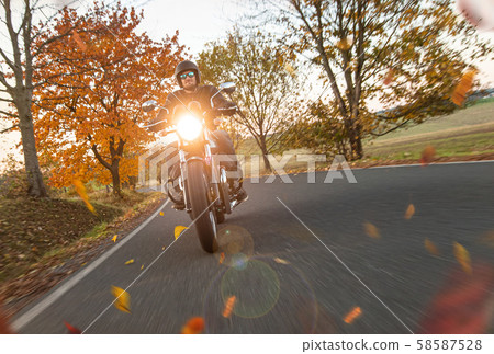 Moto racer riding on mountain road, travel to Europe. 58587528