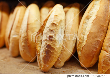 Freshly baked fragrant and crisp bread from the bakery lies and is stored on the counter for sale 58587538
