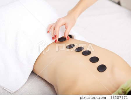 Spa. Beautiful woman spa hot stone massage beauty Treatments 58587571