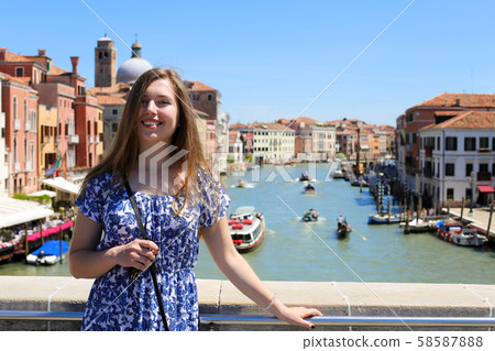 Young female tourist standing in Venice background, Italy. 58587888