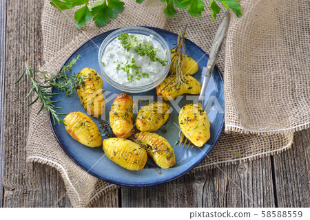 Vegetarian meal: Small potatoes baked with olive oil and served with fresh herb curd 58588559
