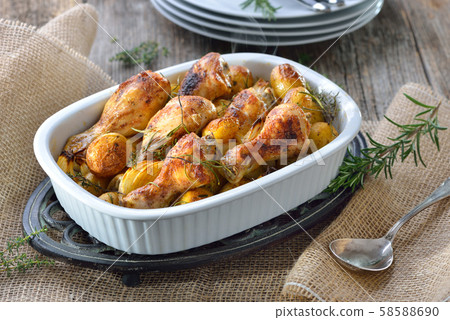 Fresh from the oven: Baked chicken drumsticks with small potatoes and onions Fresh from the oven: Baked chicken drumsticks with small potatoes and onions 58588690