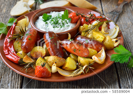 Spanish meal: Baked hot chorizo sausages with rosemary vegetables and mediterranean herb curd Spanish meal: Baked hot chorizo sausages with rosemary vegetables and mediterranean herb curd 58589004