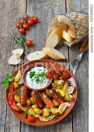 Spanish meal: Baked hot chorizo sausages with rosemary vegetables and mediterranean herb curd Spanish meal: Baked hot chorizo sausages with rosemary vegetables and mediterranean herb curd 58589005