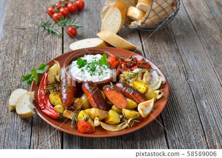 Spanish meal: Baked hot chorizo sausages with rosemary vegetables and mediterranean herb curd 58589006