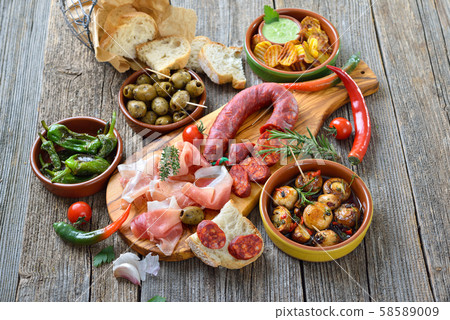 Typical Iberian bar food: Spicy chorizo sausage, Serrano ham and other mixed tapas 58589009