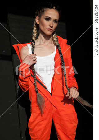 portrait of a beautiful working woman in orange clothes 58589404