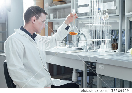 scientist conducts chemical experiments with liquids in the medical laboratory 58589939