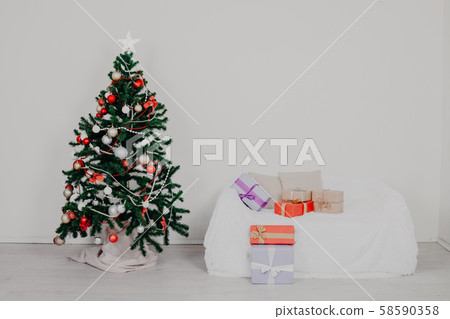 Christmas tree in the room with Christmas decorations and gifts toys Christmas tree in the room with Christmas decorations and gifts toys 58590358