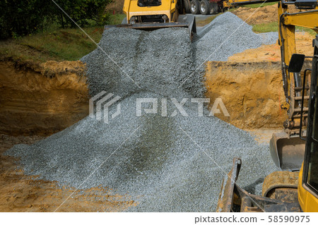 Excavator unloading gravel in the construction Excavator unloading gravel in the construction 58590975