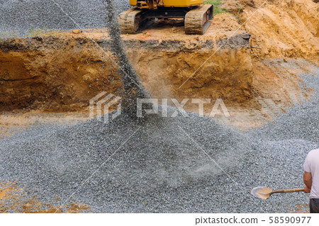 Excavator uploader moving gravel on of Excavator uploader moving gravel on of 58590977