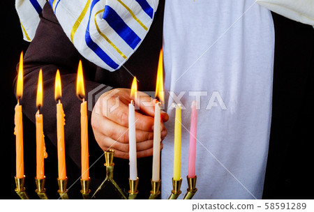 Closeup of a burning Chanukah candlestick with 58591289