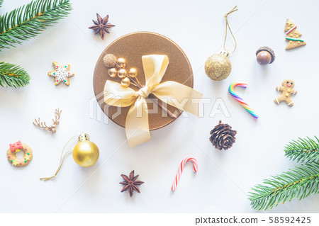 Holiday Christmas card background with festive decoration ball, stars, snowflakes, gift box, pine cones on a white background from Flat lay, top view. Space for text Merry Christmas and happy New Year Holiday Christmas card background with festive decoration ball, stars, snowflakes, gift box, pine cones on a white background from Flat lay, top view. Space for text Merry Christmas and happy New Year 58592425