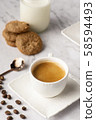 Hot coffee and cookie on white table 58594493